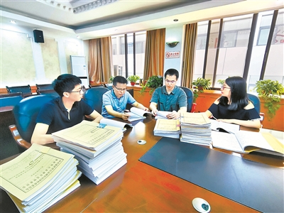 圖為九龍坡區(qū)紀(jì)委監(jiān)委案件審理室工作人員研究馮海軍案定性相關(guān)證據(jù)。 向?qū)?攝